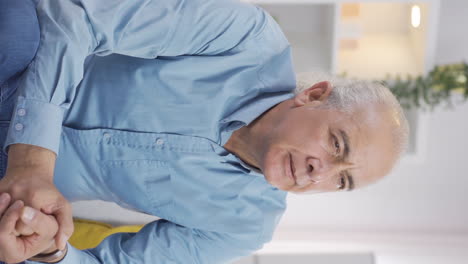Vertical-video-of-The-grieving-old-man-is-thinking-and-suffering-from-depression.